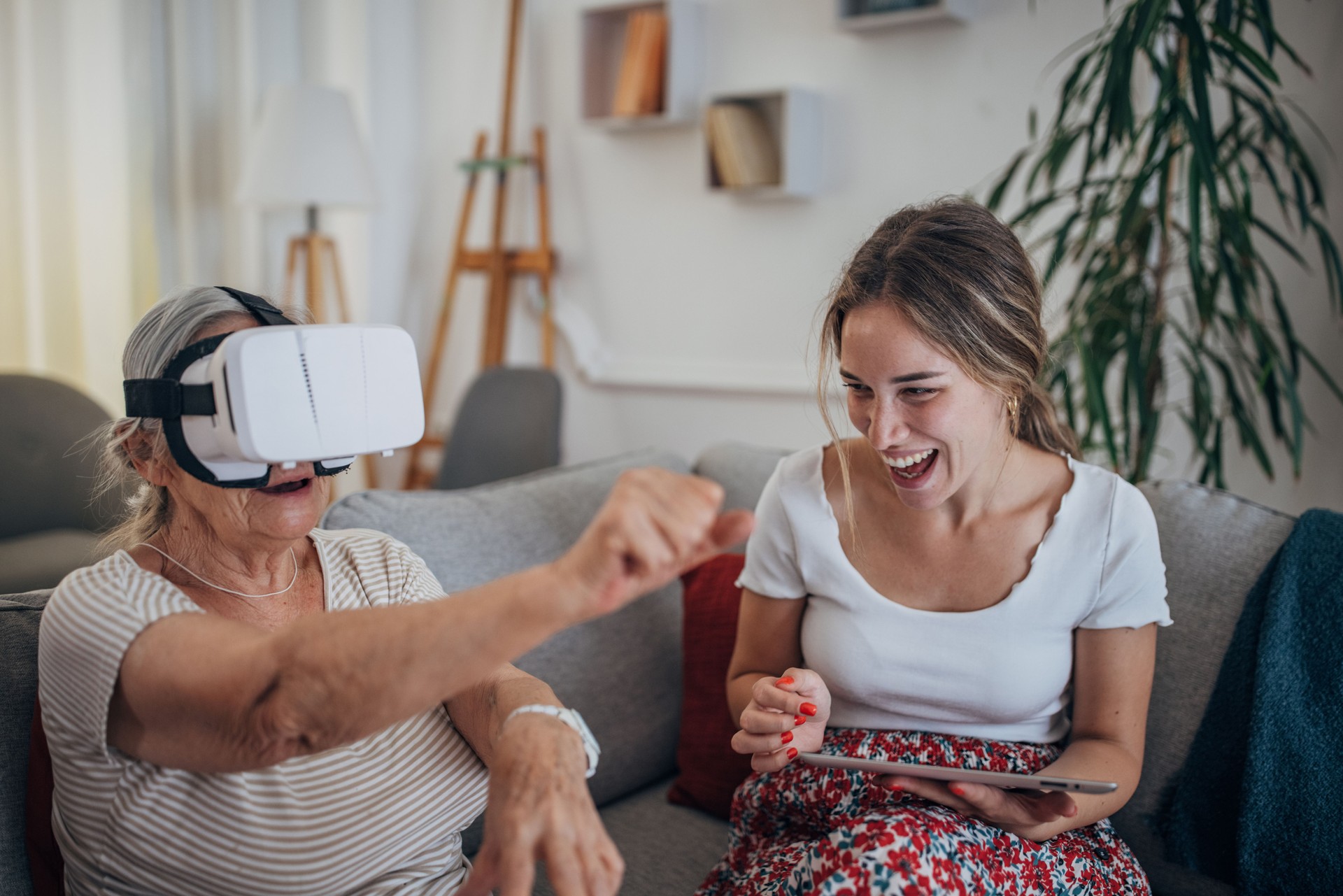 Happy Grandmother And Girl Playing with virtual reality glasses together